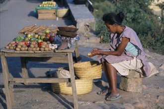 MADAGASCAR, Antananarivo, Woman selling fruit and vegetables on a roadside stall