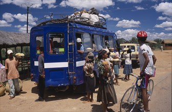 MADAGASCAR, Transport, Road to Antsirabe. Minibus at a roadside stopping point with a woman and