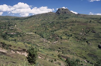MADAGASCAR, Landscape, Near Antsirabe. Terraced paddy fields and homes set into hillside