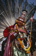 INDIA, Kerala, Thrissur, "Mayura Nritham, Peacock Dance, dancer in costume and painted face, at The