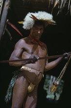 COLOMBIA, Vaupes Region, Tukano Tribe, "Shaman beats ceremonial “kurubeti” / stave to fend off evil
