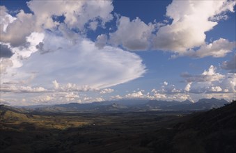 MADAGASCAR, Landscape, Road to Isalo. View across mountain range with a dramatic cloud formation