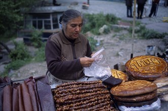ARMENIA, Market, A local snack seller on a stall at the edge of the road.