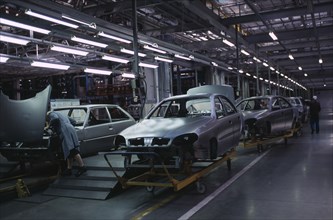 UKRAINE, Zaporozhye, Cars on trolleys awaiting completion in a production factory