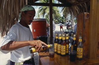 DOMINICAN REPUBLIC, People, Men, Man pouring rum into a glass at a Tiki style bar