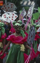 TRINIDAD, Festivals, Carnival precession with girls dressed in pink and green costumes holding