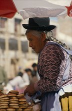 BOLIVIA, Uyuni, An elderly woman at a market stall.