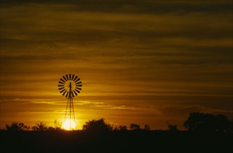 AUSTRALIA, Western , Orange sunset over silhouetted windmill near Fitzroy Crossing.