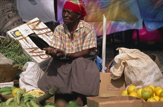 DUTCH ANTILES, St Maarten, Marigot, Woman stallholder in fruit and vegetable market.