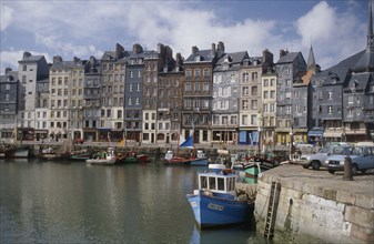 FRANCE, Normandy, Calvados, "Honfleur harbour with fishing boats moored against stone quay