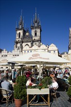CZECH REPUBLIC, Bohemia, Prague, People sitting at restaurant tables under umbrellas in the Old