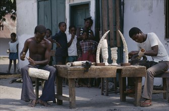 CONGO, Craft, Ivory carvers working outside with watching children.