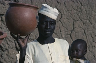NIGERIA, Jos, Portrait of potter and his son.