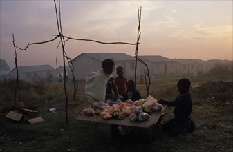 SOUTH AFRICA, Eastern Cape, Port Elizabeth, Women and children selling fruit from makeshift stall