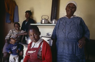 SOUTH AFRICA, Gauteng, Soweto, Portrait of family in domestic interior.