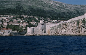 CROATIA, Dalmatia, Dubrovnik, View across water towards the Old City fortifications along the