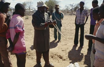 ZIMBABWE, Buhera District, Water prospector using divining rods to show where water can be found.
