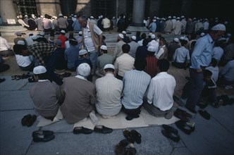 TURKEY, Istanbul, Muslim men and boys at prayer at the Sultan Ahmet Cami or Blue Mosque.