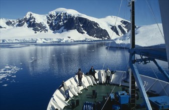 ANTARCTICA, Peninsula Region, View of the front section of a ship with people standing looking over