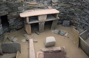 SCOTLAND, Orkney, Skara Brae, View inside one of the Neolithic stone houses in the settlement
