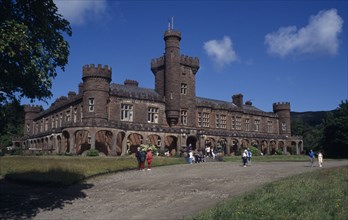 SCOTLAND, Inverness shire, Isle of Rum, Kinloch Castle exterior with visitors in grounds. Built in