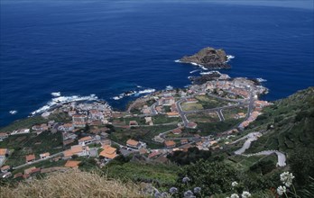 PORTUGAL, Madeira, Elevated view from the north coast road over Porto do Moniz rooftops and