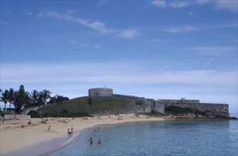 BERMUDA, St George Parish, Fort St Catherine behind St Catherines Beach with people on the sand and