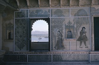 INDIA, Rajasthan, Udaipur, City Palace interior detail with painted walls and arched window framing
