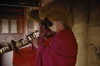 CHINA, Qinghai Province, Quezhang Lamasery, Tibetan Yellow Hat Buddhists playing long trumpet horns