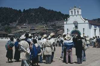 MEXICO, Chiapas, San Juan Chamula, Crowd gathered in square outside church in village where both