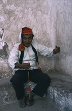 PERU, Puno, Lake Titicaca, Taquile man spinning wool.