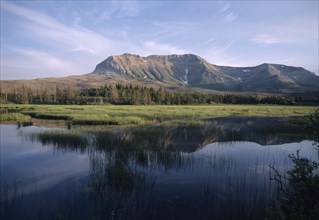 CANADA, Alberta, Waterton Lakes N.P., Landscape with Sofa Mountain reflected in lake.
