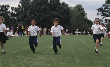ENGLAND, Sport, Five year olds taking part in running race during school sports day.