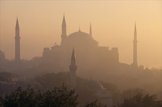 TURKEY, Istanbul, "Dome and minarets of Haghia Sophia silhouetted against hazy, pale orange sky