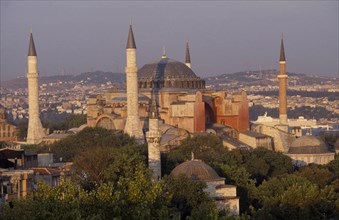 TURKEY, Istanbul, Dome and minarets of Haghia Sophia amongst rooftops of the Sultanahmet.  Former