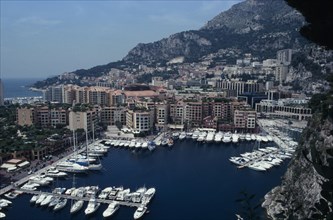 MONACO, Fontvielle, Elevated view over harbour with moored yachts on water towards tall buildings