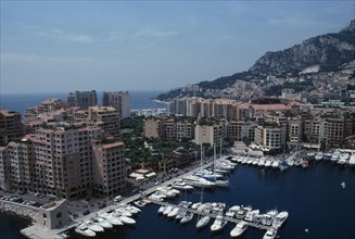 MONACO, Fontvielle, Elevated view over harbour with moored yachts on water towards tall buildings