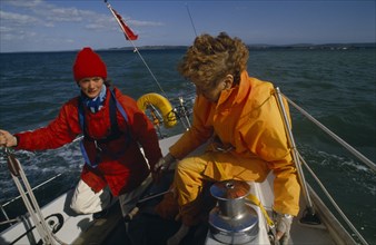 ENGLAND, Dorset, Lymington, Female crew on yacht preparing for trans-Atlantic race.