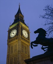 ENGLAND, London, Westminster. Big Ben Clock Tower and the statue of Boudicea in silhouette in the