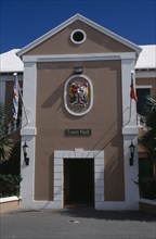 BERMUDA, St George, Kings Square. Town Hall exterior with crest above door  entrance and flagpoles