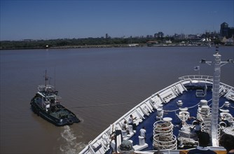 ARGENTINA, Buenos Aires, View of front section of ship in the docks with a tug boat attached