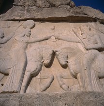 IRAN, Fars Province, Naghshe Rostam, Sassanian relief. Two Stone carved figures on horseback