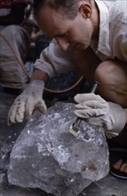MADAGASCAR, Industry, Quartz dealer examining a crystal