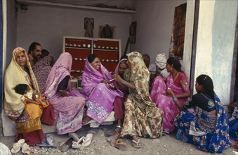 INDIA, Madhya Pradesh, Shampur, Women buying silver jewellery.