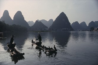 CHINA, Guangxi Province, River Li, Cormorant fishermen on stretch of river in the Guilin area with