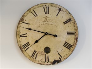 FRANCE, Deux Sevres Region, Poitiers, A classic clock face with Roman numerals against a plain