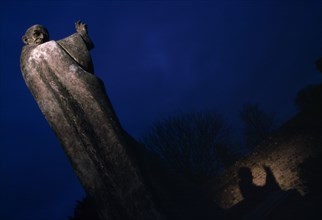 ENGLAND, West Sussex, Chichester, Statue of Saint Richard partially illuminated at night in