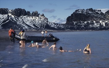 ANTARCTICA, Peninsula Region, Deception Island, Tourists swimming in geothermally heated water