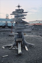 ANTARCTICA, King George Island, Russian Bellingshausen Station. Wooden sign post with star on top