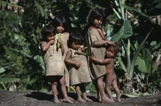 COLUMBIA, Kogi , Kogi Indian children affectionately holding on to each other carrying sticks of